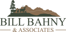 Logo for Bill Bahny & Associates featuring silhouettes of elk and a tree in front of mountain outlines, with the company name written below in green and brown text—ideal for those seeking Montana ranches or ranch homes.