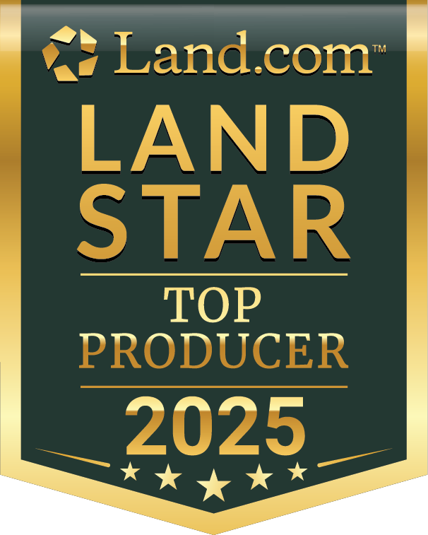 Asset 59LSA_Annual_2025 A gold and dark green badge reads: Land.com LAND STAR TOP PRODUCER 2025 with a gold border and five stars at the bottom—an emblem of excellence for those specializing in Montana ranches for sale.