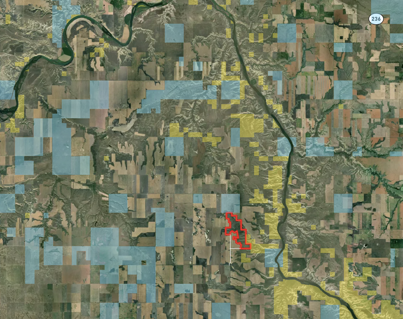 A satellite map shows a river winding through patchwork fields and forests. Highlighted areas in blue and yellow mark certain zones; a red outline marks a distinct area near the center. Highway 236 is labeled at the top right.